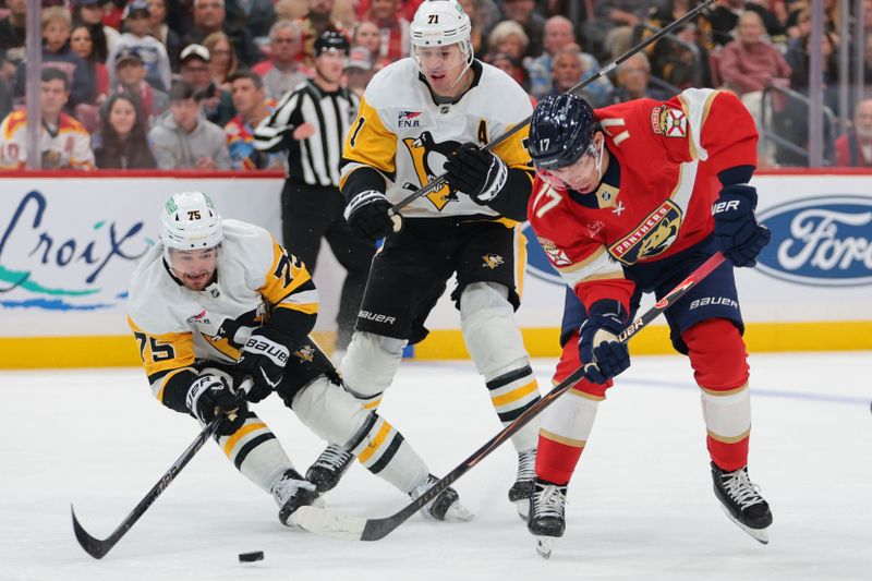 Oct 23, 2025; Sunrise, Florida, USA; Florida Panthers center Evan Rodrigues (17) moves the puck against Pittsburgh Penguins defenseman Connor Clifton (75) during the second period at Amerant Bank Arena. Mandatory Credit: Sam Navarro-Imagn Images