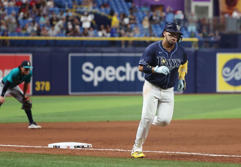 Jun 25, 2024; St. Petersburg, Florida, USA; Tampa Bay Rays third baseman Isaac Paredes (17) hits a home run against the Seattle Mariners during the eighth inning at Tropicana Field. Mandatory Credit: Kim Klement Neitzel-USA TODAY Sports