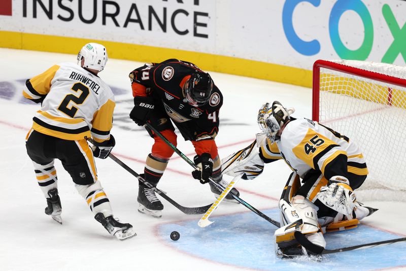 Nov 7, 2023; Anaheim, California, USA; Pittsburgh Penguins goaltender Magnus Hellberg (45) defends the goal against Anaheim Ducks left wing Ross Johnston (44) during the third period at Honda Center. Mandatory Credit: Kiyoshi Mio-USA TODAY Sports