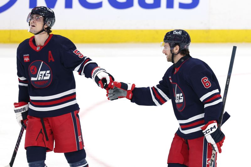 Mar 23, 2025; Winnipeg, Manitoba, CAN; Winnipeg Jets defenseman Colin Miller (6) celebrates after a goal against the Buffalo Sabres with Winnipeg Jets center Mark Scheifele (55) in the third period at Canada Life Centre. Mandatory Credit: James Carey Lauder-Imagn Images