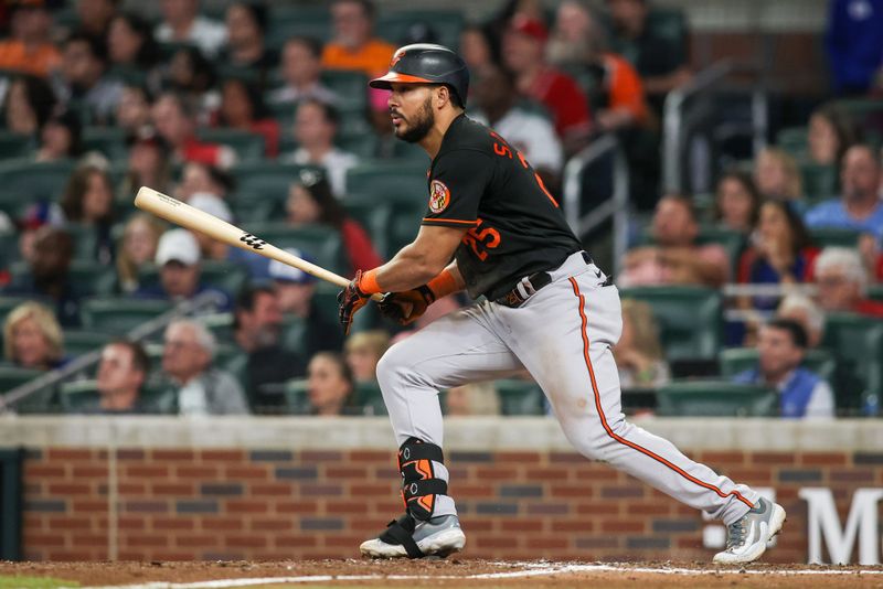May 6, 2023; Atlanta, Georgia, USA; Baltimore Orioles right fielder Anthony Santander (25) hits a RBI double against the Atlanta Braves in the sixth inning at Truist Park. Mandatory Credit: Brett Davis-USA TODAY Sports