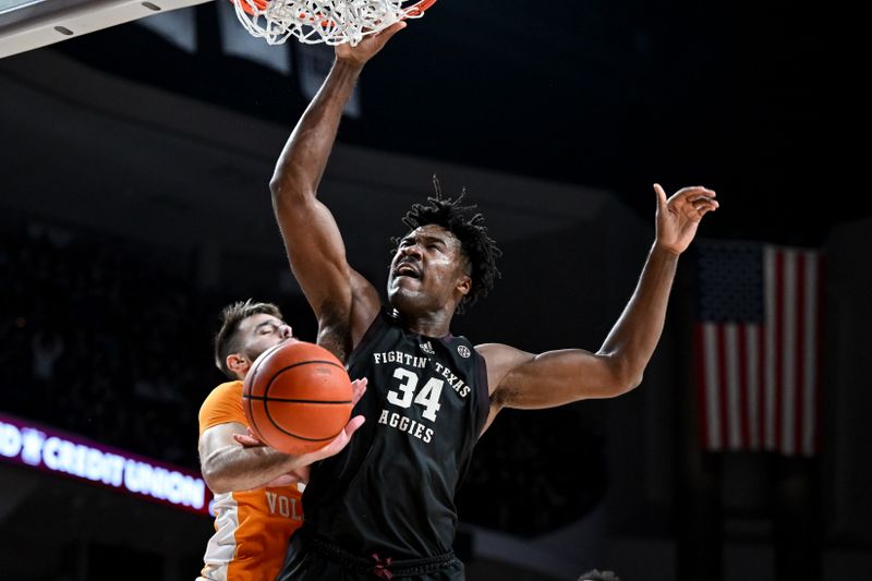 Feb 21, 2023; College Station, Texas, USA;  Texas A&M Aggies forward Julius Marble (34) dunks against Tennessee Volunteers guard Santiago Vescovi (25) during the second half at Reed Arena. Mandatory Credit: Maria Lysaker-USA TODAY Sports