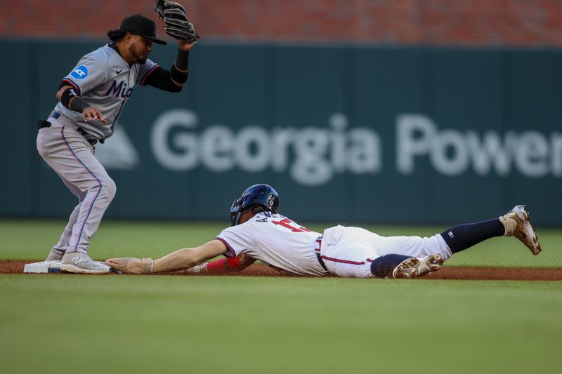 Apr 22, 2024; Atlanta, Georgia, USA; Atlanta Braves right fielder Ronald Acuna Jr. (13) steals second in front of Miami Marlins second baseman Luis Arraez (3) in the first inning at Truist Park. Mandatory Credit: Brett Davis-USA TODAY Sports
