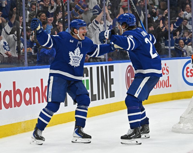 Oct 13, 2025; Toronto, Ontario, CAN; Toronto Maple Leafs left wing Matthew Knies (23) celebrates his goal with center Bobby McMann (74) in the third period  at Scotiabank Arena. Mandatory Credit: Gerry Angus-Imagn Images