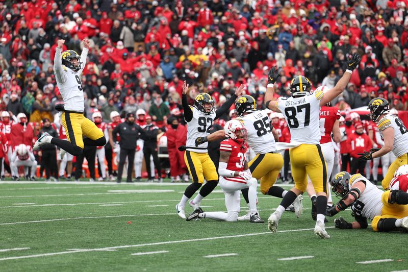 Nov 24, 2023; Lincoln, Nebraska, USA; Iowa Hawkeyes kicker Marshall Meeder (82) celebrates with teammates after kicking the game winning field goal against the Nebraska Cornhuskers at Memorial Stadium. Mandatory Credit: Reese Strickland-USA TODAY Sports