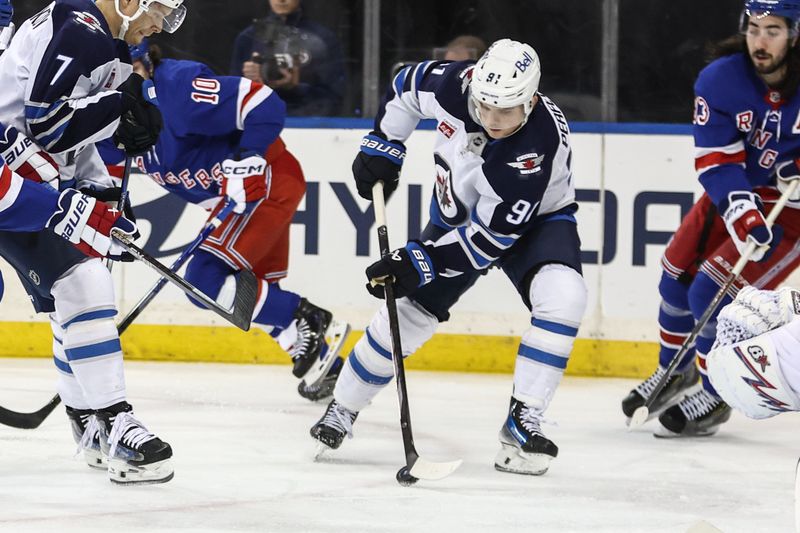 Nov 12, 2024; New York, New York, USA;  Winnipeg Jets center Cole Perfetti (91) controls the puck in the third period against the Winnipeg Jets at Madison Square Garden. Mandatory Credit: Wendell Cruz-Imagn Images