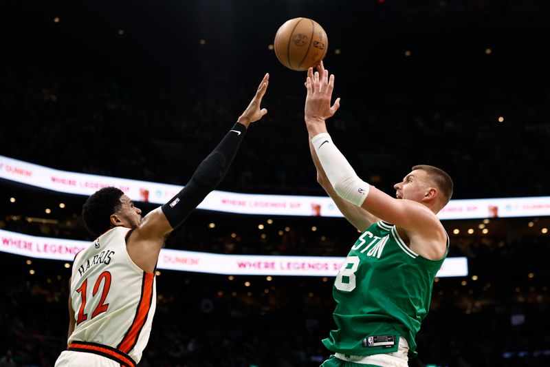 BOSTON, MA - DECEMBER 4: Kristaps Porzingis #8 of the Boston Celtics shoots over Tobias Harris #12 of the Detroit Pistons during the second half at TD Garden on December 4, 2024 in Boston, Massachusetts. NOTE TO USER: User expressly acknowledges and agrees that, by downloading and/or using this Photograph, user is consenting to the terms and conditions of the Getty Images License Agreement. (Photo By Winslow Townson/Getty Images)