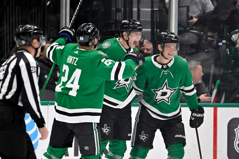 Nov 14, 2023; Dallas, Texas, USA; Dallas Stars center Roope Hintz (24) and defenseman Esa Lindell (23) and defenseman Nils Lundkvist (5) celebrates a goal scored by Lindell against the Arizona Coyotes during the first period at the American Airlines Center. Mandatory Credit: Jerome Miron-USA TODAY Sports