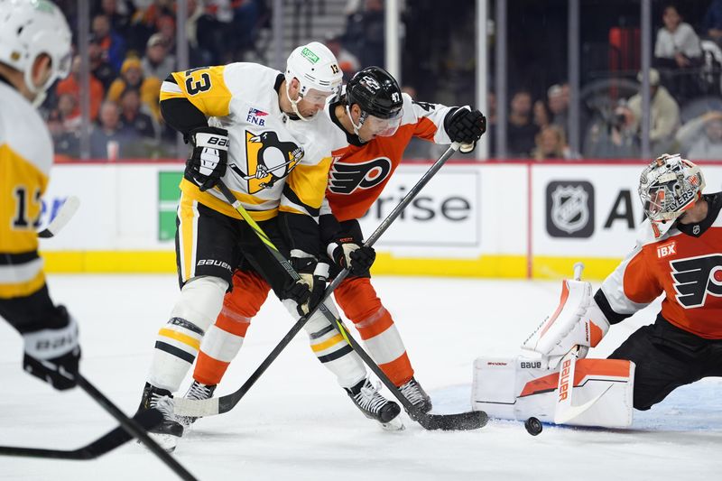Dec 1, 2025; Philadelphia, Pennsylvania, USA; Pittsburgh Penguins right wing Kevin Hayes (13) and Philadelphia Flyers defenseman Noah Juulsen (47) battle for the puck in the second period at Xfinity Mobile Arena. Mandatory Credit: Kyle Ross-Imagn Images