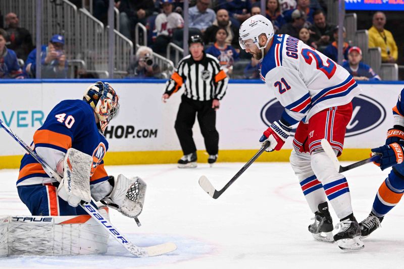 Apr 9, 2024; Elmont, New York, USA; New York Islanders goaltender Semyon Varlamov (40) makes a save on New York Rangers center Barclay Goodrow (21) during the first period at UBS Arena. Mandatory Credit: Dennis Schneidler-USA TODAY Sports