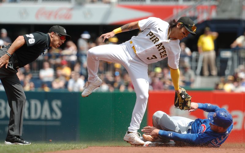 Aug 27, 2023; Pittsburgh, Pennsylvania, USA;  Chicago Cubs designated hitter Cody Bellinger (right) steals second base as Pittsburgh Pirates second baseman Ji Hwan Bae (3) applies a late tag during the first inning at PNC Park. Mandatory Credit: Charles LeClaire-USA TODAY Sports