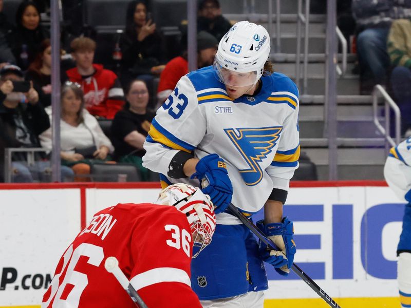 Oct 25, 2025; Detroit, Michigan, USA;  Detroit Red Wings goaltender John Gibson (36) makes the save in front of St. Louis Blues left wing Jake Neighbours (63) in the first period at Little Caesars Arena. Mandatory Credit: Rick Osentoski-Imagn Images