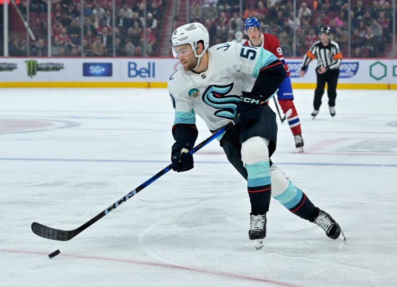 Oct 29, 2024; Montreal, Quebec, CAN; Seattle Kraken forward Shane Wright (51) plays the puck during the third period against the Montreal Canadiens at the Bell Centre. Mandatory Credit: Eric Bolte-Imagn Images