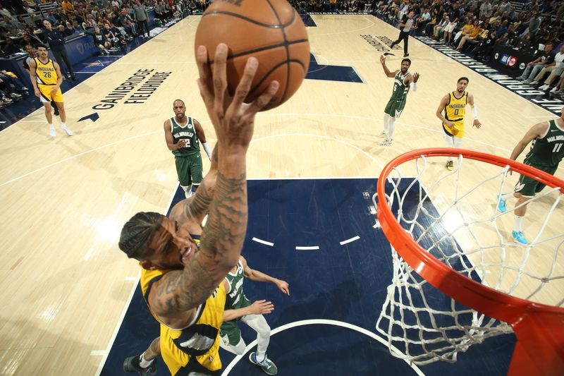 INDIANAPOLIS, IN - APRIL 28: Obi Toppin #1 of the Indiana Pacers dunks the ball during the game against the Milwaukee Bucks during Round 1 Game 4 of the 2024 NBA Playoffs on April 28, 2024 at Gainbridge Fieldhouse in Indianapolis, Indiana. NOTE TO USER: User expressly acknowledges and agrees that, by downloading and or using this Photograph, user is consenting to the terms and conditions of the Getty Images License Agreement. Mandatory Copyright Notice: Copyright 2024 NBAE (Photo by Nathaniel S. Butler/NBAE via Getty Images)