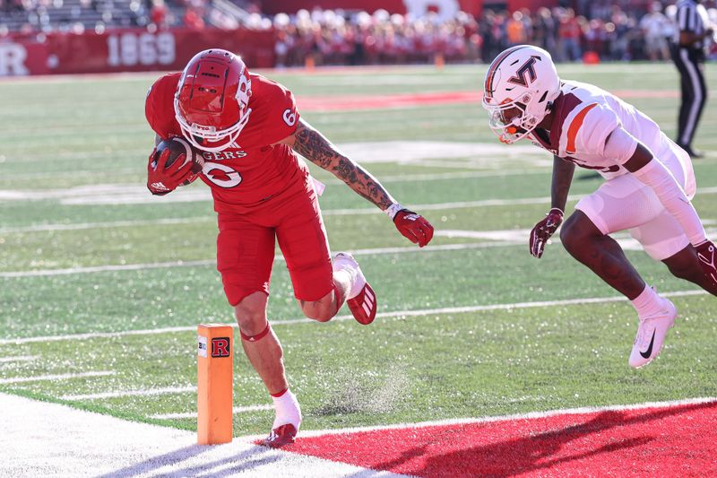 Sep 16, 2023; Piscataway, New Jersey, USA; Rutgers Scarlet Knights wide receiver Christian Dremel (6) catches a touchdown pass in front of Virginia Tech Hokies safety Jaylen Jones (15) during the first half against the Virginia Tech Hokies at SHI Stadium. Mandatory Credit: Vincent Carchietta-USA TODAY Sports