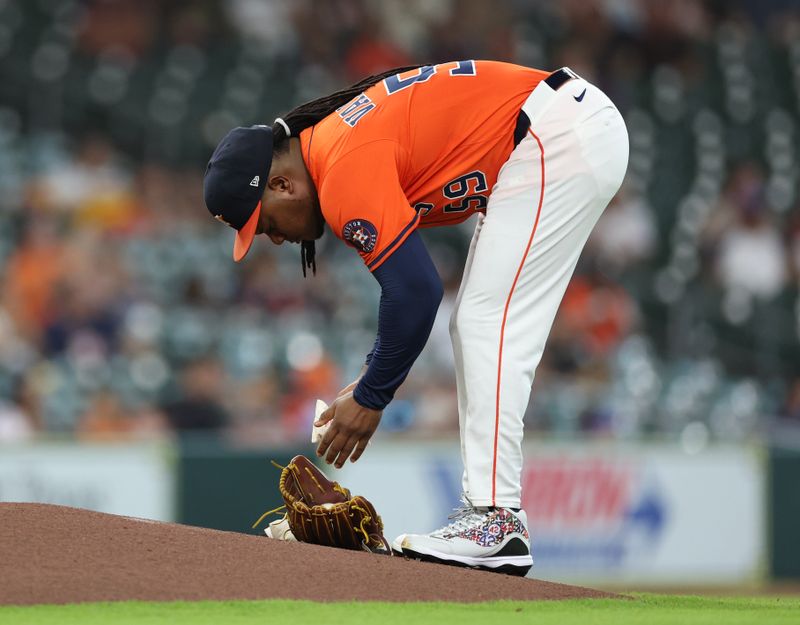 May 13, 2025; Houston, Texas, USA; Houston Astros starting pitcher Framber Valdez (59) grabs the rosin bag before pitching against the Kansas City Royals at Daikin Park. Mandatory Credit: Thomas Shea-Imagn Images