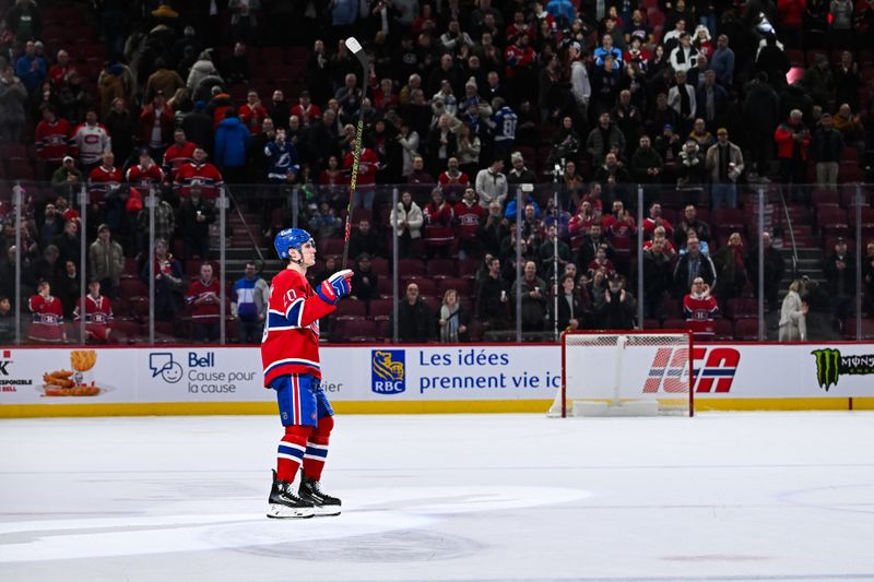 Jan 21, 2025; Montreal, Quebec, CAN; Third star of the week Montreal Canadiens left wing Juraj Slafkovsky (20) salutes the crowd after defeating the Tampa Bay Lightning at Bell Centre. Mandatory Credit: David Kirouac-Imagn Images