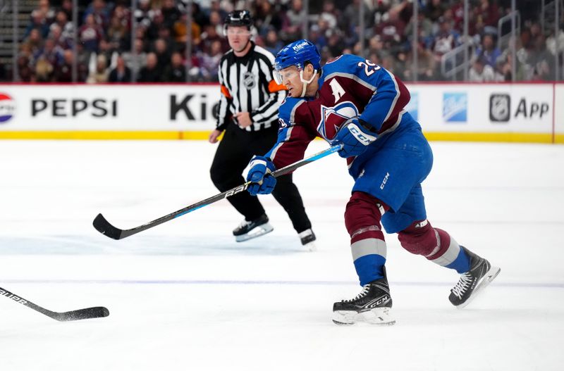 Feb 20, 2024; Denver, Colorado, USA; Colorado Avalanche center Nathan MacKinnon (29) shoots on goal in the second period against the Vancouver Canucks at Ball Arena. Mandatory Credit: Ron Chenoy-USA TODAY Sports