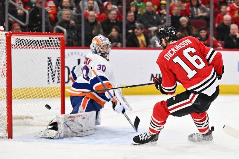 Jan 19, 2024; Chicago, Illinois, USA; Chicago Blackhawks forward Jason Dickinson (16) scores a goal on New York Islanders goaltender Ilya Sorokin (30) in the third period at United Center. Mandatory Credit: Jamie Sabau-USA TODAY Sports