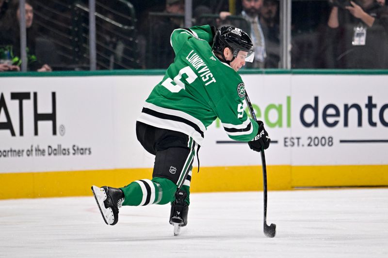 Dec 15, 2025; Dallas, Texas, USA; Dallas Stars defenseman Nils Lundkvist (5) shoots the puck in the Los Angeles Kings zone during the first period at the American Airlines Center. Mandatory Credit: Jerome Miron-Imagn Images
