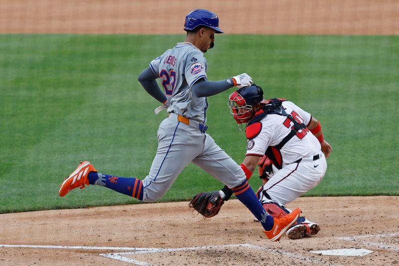 Jun 5, 2024; Washington, District of Columbia, USA; New York Mets third baseman Mark Vientos (27) scores a run as Washington Nationals catcher Keibert Ruiz (20) attempts to apply a tag during the sixth inning at Nationals Park. Mandatory Credit: Geoff Burke-USA TODAY Sports