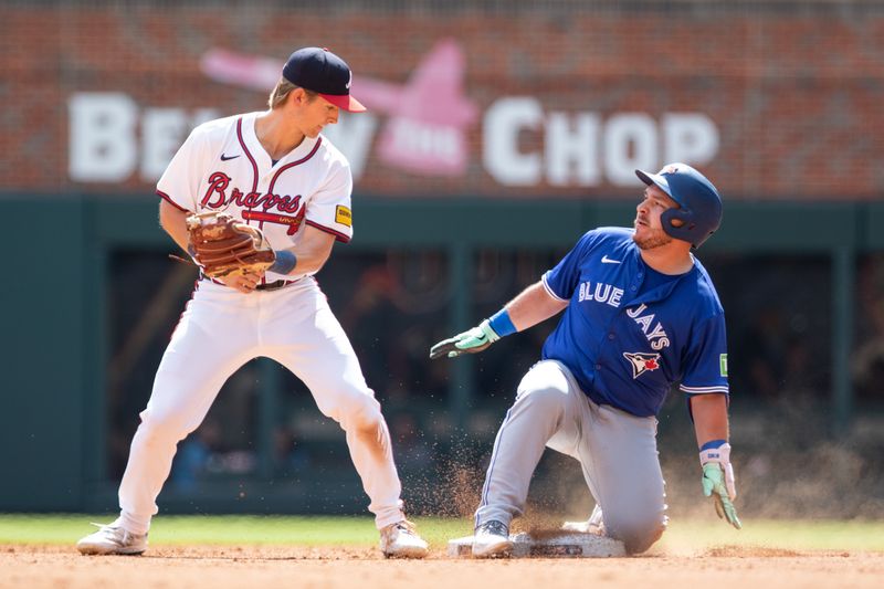 Sep 8, 2024; Cumberland, Georgia, USA; Toronto Blue Jays catcher Alejandro Kirk (30) slides into second base for the double against Atlanta Braves outfielder Luke Williams (65) during the sixth inning at Truist Park. Mandatory Credit: Jordan Godfree-Imagn Images