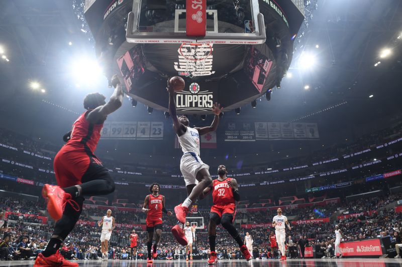 LOS ANGELES, CA - APIRL 14: Kobe Brown #21 of the LA Clippers drives to the basket during the game against the Houston Rockets on April 14, 2024 at Crypto.Com Arena in Los Angeles, California. NOTE TO USER: User expressly acknowledges and agrees that, by downloading and/or using this Photograph, user is consenting to the terms and conditions of the Getty Images License Agreement. Mandatory Copyright Notice: Copyright 2024 NBAE (Photo by Adam Pantozzi/NBAE via Getty Images)