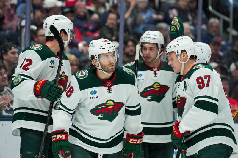 Dec 18, 2025; Columbus, Ohio, USA;  Minnesota Wild right wing Ryan Hartman (38) celebrates with teammates after scoring a goal against Columbus Blue Jackets in the second period at Nationwide Arena. Mandatory Credit: Aaron Doster-Imagn Images