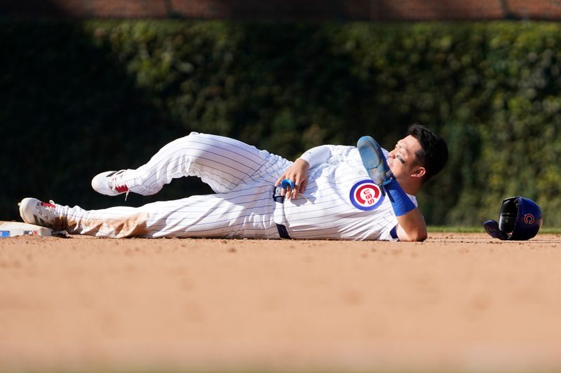 Sep 20, 2024; Chicago, Illinois, USA; Chicago Cubs outfielder Seiya Suzuki (27) steals second base and is hit by the ball against the Washington Nationals during the eighth inning at Wrigley Field. Mandatory Credit: David Banks-Imagn Images