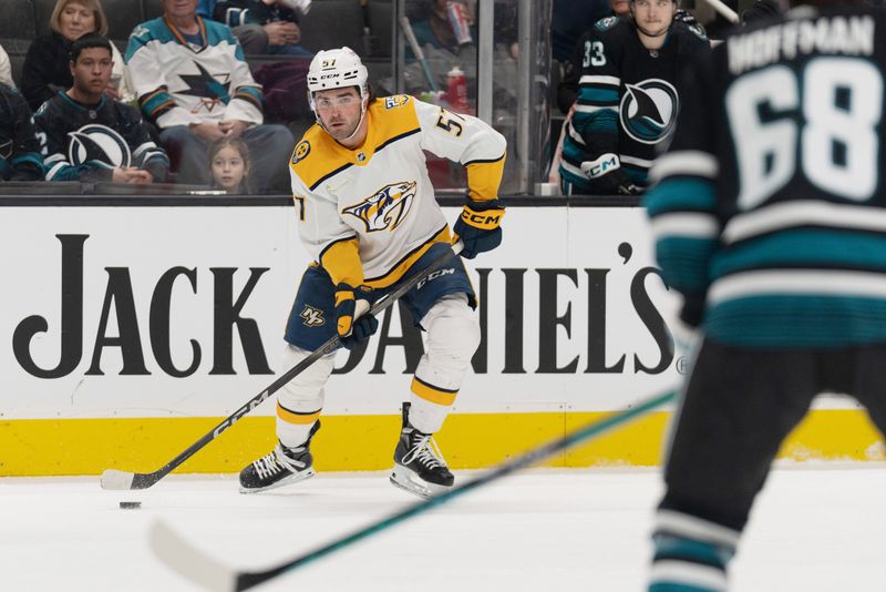 Feb 24, 2024; San Jose, California, USA; Nashville Predators defenseman Dante Fabbro (57) controls the puck during the first period against San Jose Sharks center Mike Hoffman (68) at SAP Center at San Jose. Mandatory Credit: Stan Szeto-USA TODAY Sports