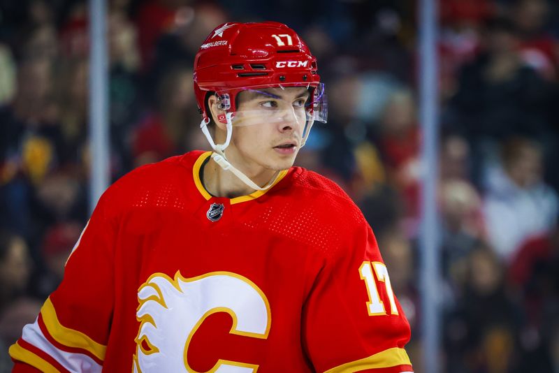 Mar 4, 2024; Calgary, Alberta, CAN; Calgary Flames center Yegor Sharangovich (17) during the face off against the Seattle Kraken during the first period at Scotiabank Saddledome. Mandatory Credit: Sergei Belski-USA TODAY Sports