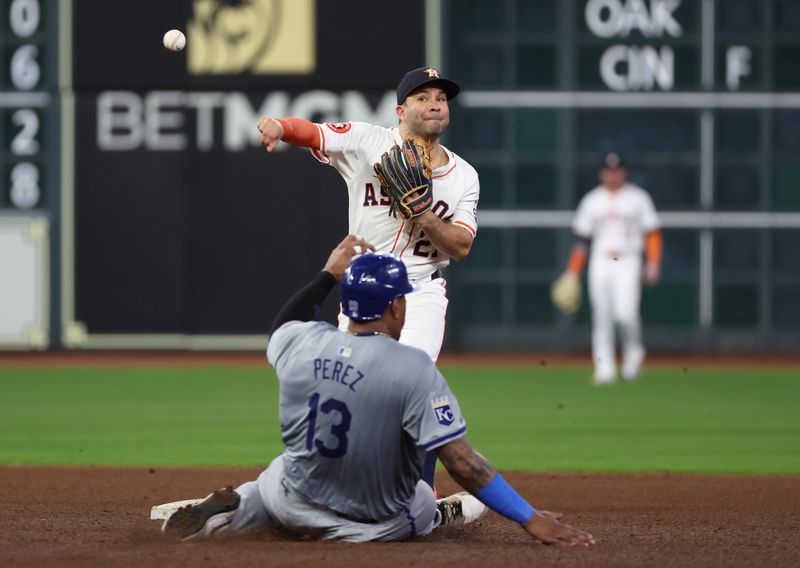 Aug 29, 2024; Houston, Texas, USA; Houston Astros second baseman Jose Altuve (27) forces out Kansas City Royals catcher Salvador Perez (13) at second base in the seventh inning at Minute Maid Park. Mandatory Credit: Thomas Shea-USA TODAY Sports