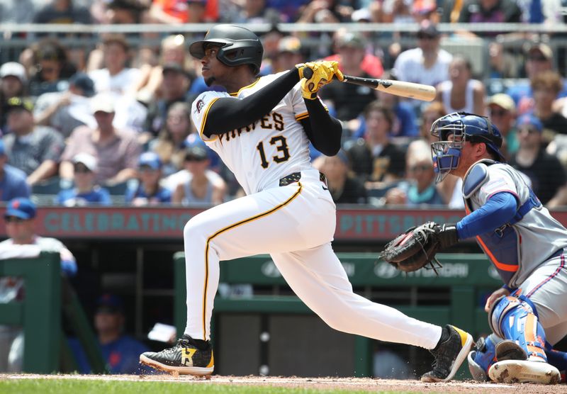 Jun 29, 2025; Pittsburgh, Pennsylvania, USA;  Pittsburgh Pirates third baseman Ke'Bryan Hayes (13) hits a two run single against the New York Mets during the first inning at PNC Park. Mandatory Credit: Charles LeClaire-Imagn Images