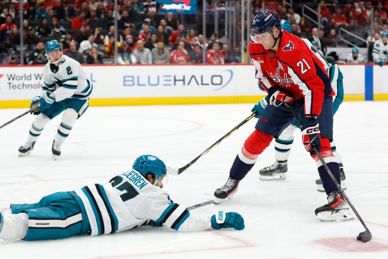 Dec 3, 2024; Washington, District of Columbia, USA; Washington Capitals center Aliaksei Protas (21) attempts to skat with the puck around the slide of San Jose Sharks defenseman Timothy Liljegren (37) in the third period at Capital One Arena. Mandatory Credit: Geoff Burke-Imagn Images