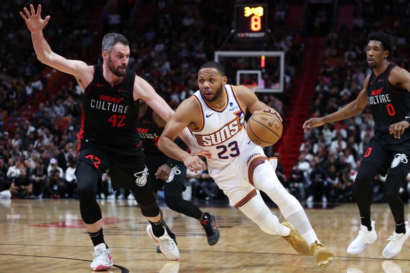 MIAMI, FLORIDA - JANUARY 29: Eric Gordon #23 of the Phoenix Suns drives against Kevin Love #42 of the Miami Heat during the second quarter of the game at Kaseya Center on January 29, 2024 in Miami, Florida. NOTE TO USER: User expressly acknowledges and agrees that, by downloading and or using this photograph, User is consenting to the terms and conditions of the Getty Images License Agreement. (Photo by Megan Briggs/Getty Images)