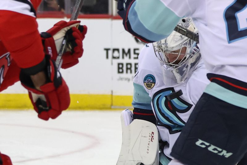 Dec 6, 2024; Newark, New Jersey, USA; Seattle Kraken goaltender Philipp Grubauer (31) makes a save against the New Jersey Devils during the second period at Prudential Center. Mandatory Credit: Ed Mulholland-Imagn Images