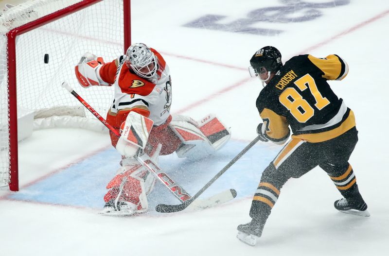 Oct 31, 2024; Pittsburgh, Pennsylvania, USA;  Pittsburgh Penguins center Sidney Crosby (87) scores the game winning goal against Anaheim Ducks goaltender Lukas Dostal (1) in overtime at PPG Paints Arena. Mandatory Credit: Charles LeClaire-Imagn Images