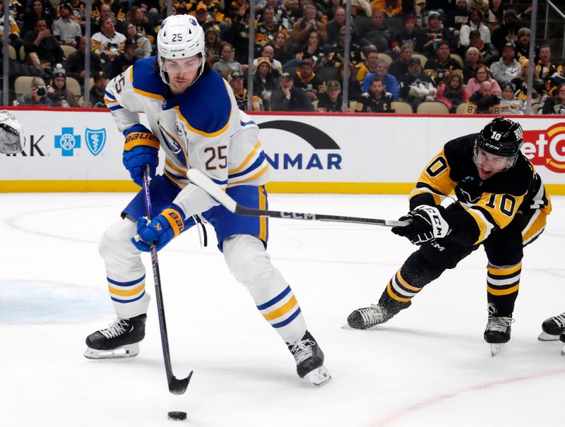 Jan 6, 2024; Pittsburgh, Pennsylvania, USA;  Buffalo Sabres defenseman Owen Power (25) handles the puck against Pittsburgh Penguins left wing Drew O'Connor (10) during the third period at PPG Paints Arena.Buffalo won 3-1. Mandatory Credit: Charles LeClaire-USA TODAY Sports