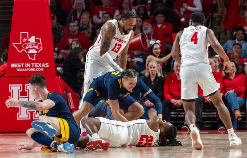 Jan 6, 2024; Houston, Texas, USA; West Virginia Mountaineers forward Patrick Suemnick (24) and Houston Cougars forward Joseph Tugler (25) reach for a loose ball in the first half  at Fertitta Center. Mandatory Credit: Thomas Shea-USA TODAY Sports