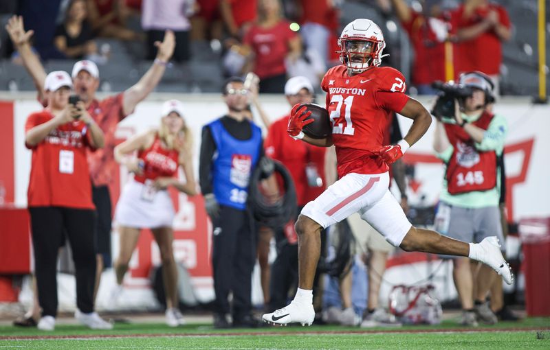 Sep 23, 2023; Houston, Texas, USA; Houston Cougars running back Stacy Sneed (21) runs with the ball and scores a touchdown during the third quarter against the Sam Houston State Bearkats at TDECU Stadium. Mandatory Credit: Troy Taormina-USA TODAY Sports