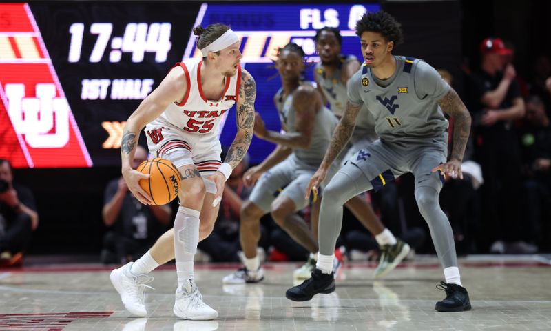 Mar 4, 2025; Salt Lake City, Utah, USA; Utah Utes guard Gabe Madsen (55) moves the ball against West Virginia Mountaineers guard Jonathan Powell (11) during the first half at Jon M. Huntsman Center. Mandatory Credit: Rob Gray-Imagn Images