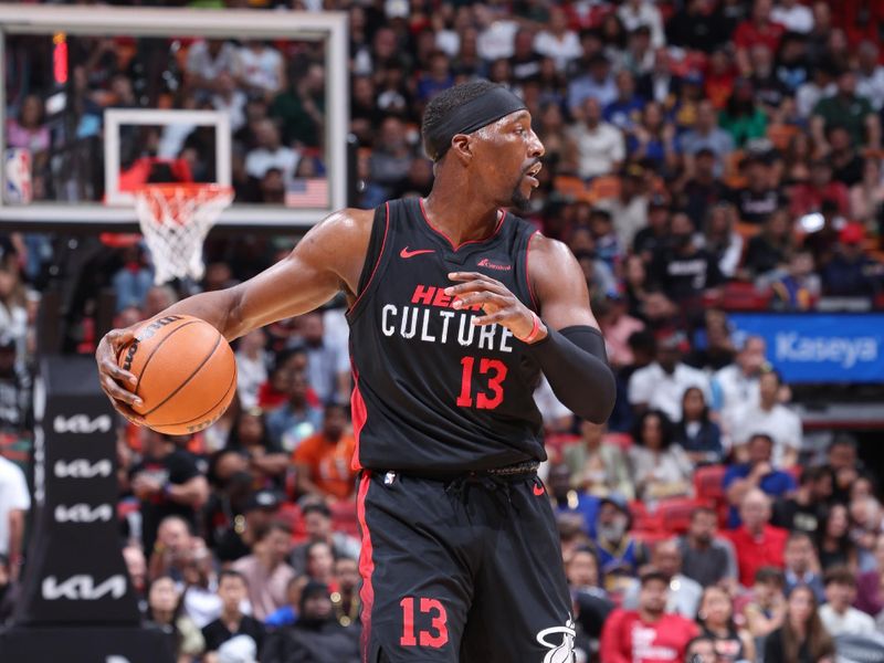 MIAMI, FL - MARCH 26:  Bam Adebayo #13 of the Miami Heat dribbles the ball during the game against the Golden State Warriors on March 26, 2024 at Kaseya Center in Miami, Florida. NOTE TO USER: User expressly acknowledges and agrees that, by downloading and or using this Photograph, user is consenting to the terms and conditions of the Getty Images License Agreement. Mandatory Copyright Notice: Copyright 2024 NBAE (Photo by Jeff Haynes/NBAE via Getty Images)