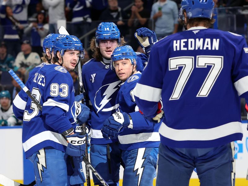 Dec 5, 2024; Tampa, Florida, USA; Tampa Bay Lightning right wing Cam Atkinson (13) celebrates with defenseman Victor Hedman (77), center Conor Geekie (14) and center Gage Goncalves (93) after he scored against the San Jose Sharks during the first period at Amalie Arena. Mandatory Credit: Kim Klement Neitzel-Imagn Images