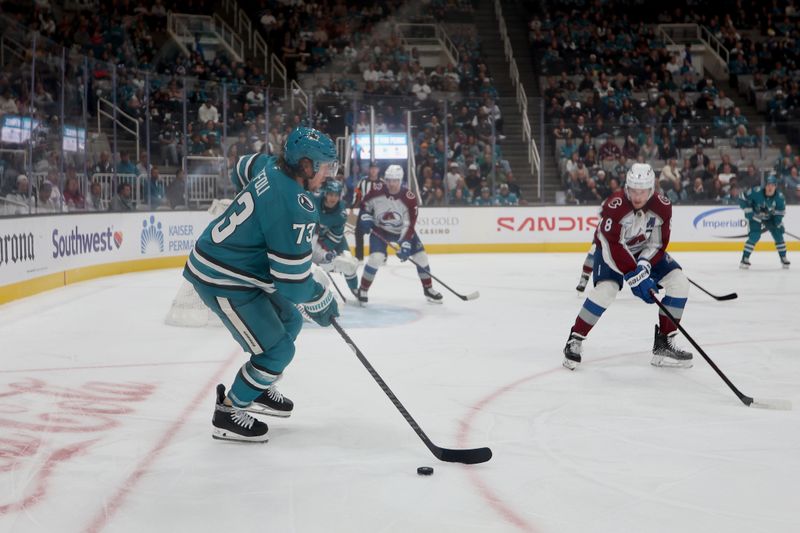 Nov 1, 2025; San Jose, California, USA; San Jose Sharks center Tyler Toffoli (73) plays the puck against Colorado Avalanche defenseman Cale Makar (8) during the first period at SAP Center at San Jose. Mandatory Credit: Dennis Lee-Imagn Images