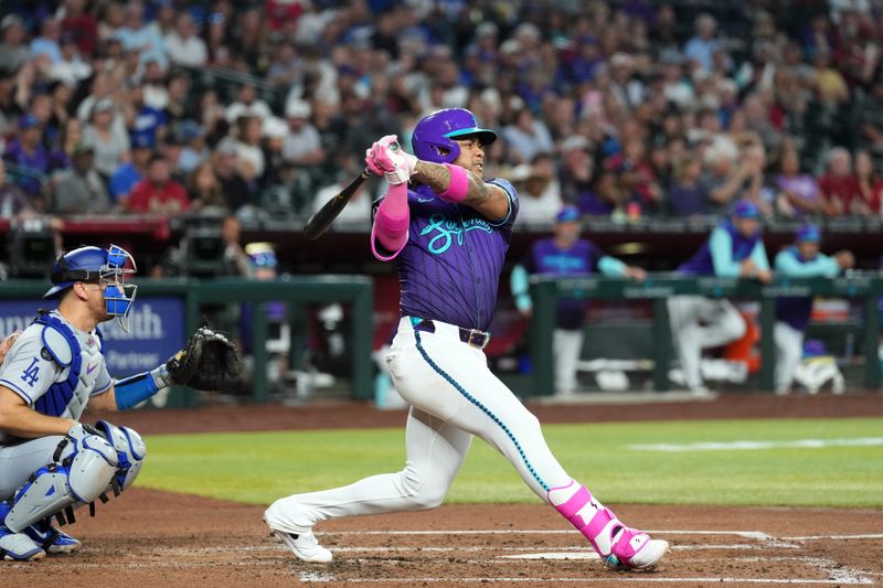 May 10, 2025; Phoenix, Arizona, USA; Arizona Diamondbacks second base Ketel Marte (4) hits an RBI groundout against the Los Angeles Dodgers during the third inning at Chase Field. Mandatory Credit: Joe Camporeale-Imagn Images