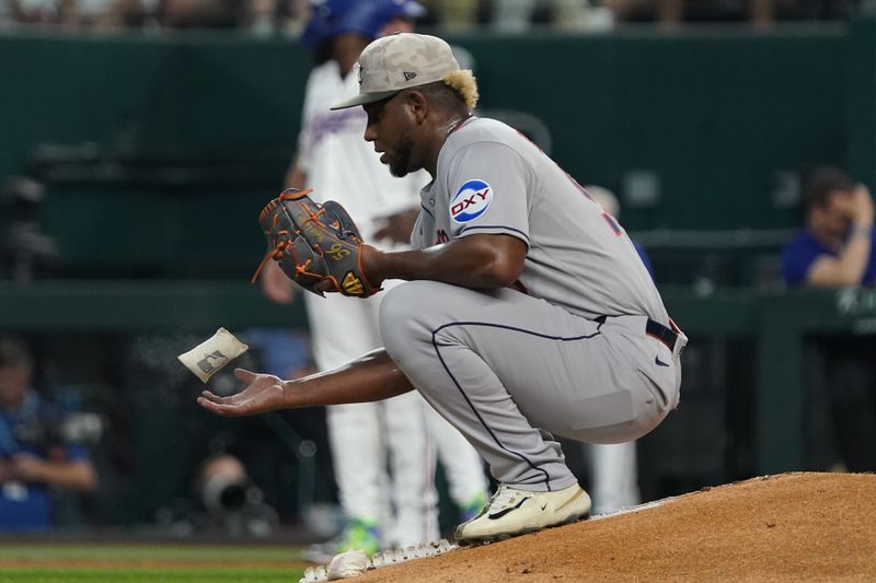 May 17, 2025; Arlington, Texas, USA; Houston Astros pitcher Ronel Blanco (56) tosses a rosin bag in the air between pitches during the third inning against the Texas Rangers at Globe Life Field. Mandatory Credit: Raymond Carlin III-Imagn Images