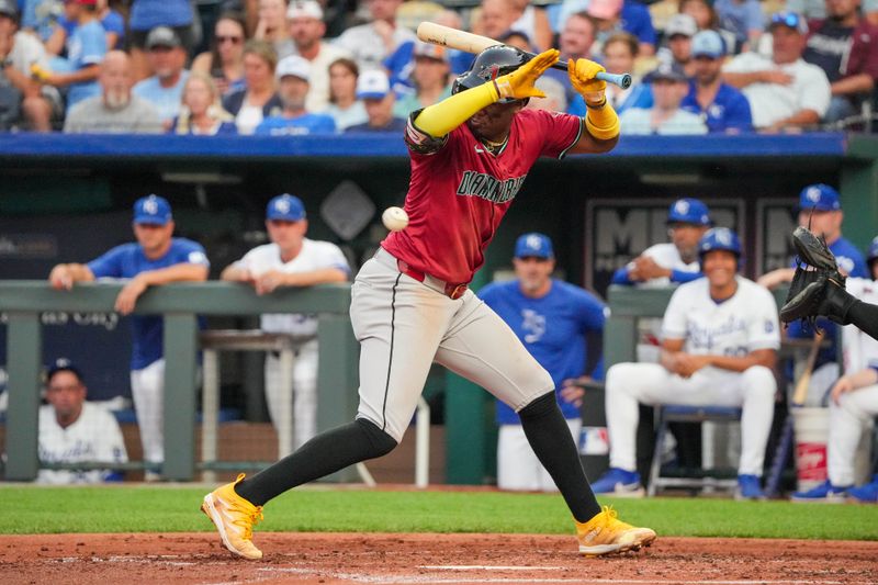 Jul 24, 2024; Kansas City, Missouri, USA; Arizona Diamondbacks shortstop Geraldo Perdomo (2) dodges an inside pitch against the Kansas City Royals in the second inning at Kauffman Stadium. Mandatory Credit: Denny Medley-USA TODAY Sports