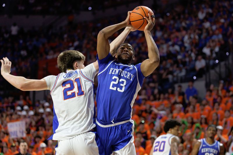 Feb 14, 2026; Gainesville, Florida, USA; Florida Gators forward Alex Condon (21) fouls Kentucky Wildcats forward Mouhamed Dioubate (23) during the first half at Exactech Arena at the Stephen C. O'Connell Center. Mandatory Credit: Matt Pendleton-Imagn Images