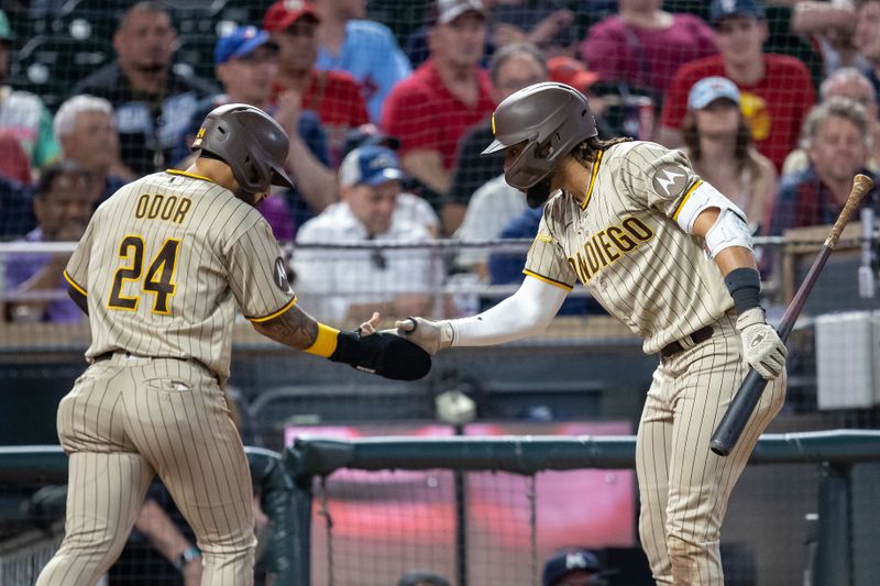 May 10, 2023; Minneapolis, Minnesota, USA; San Diego Padres second baseman Rougned Odor (24) celebrates with right fielder Fernando Tatis Jr. (23) after scoring a run in the tenth inning against the Minnesota Twins at Target Field. Mandatory Credit: Jesse Johnson-USA TODAY Sports