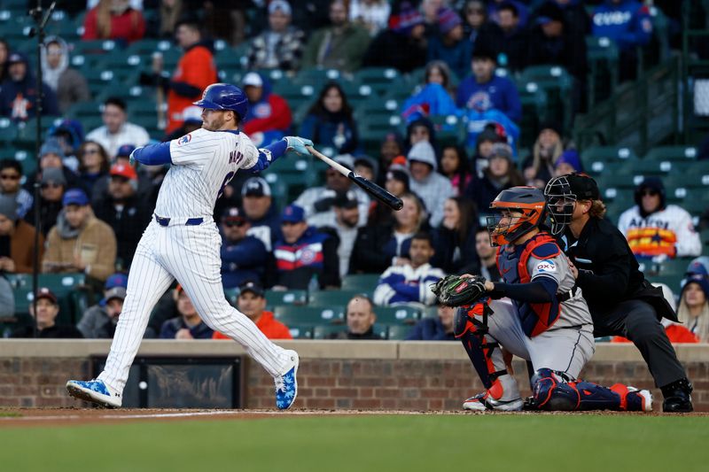 Apr 24, 2024; Chicago, Illinois, USA; Chicago Cubs outfielder Ian Happ (8) singles against the Houston Astros during the first inning at Wrigley Field. Mandatory Credit: Kamil Krzaczynski-USA TODAY Sports